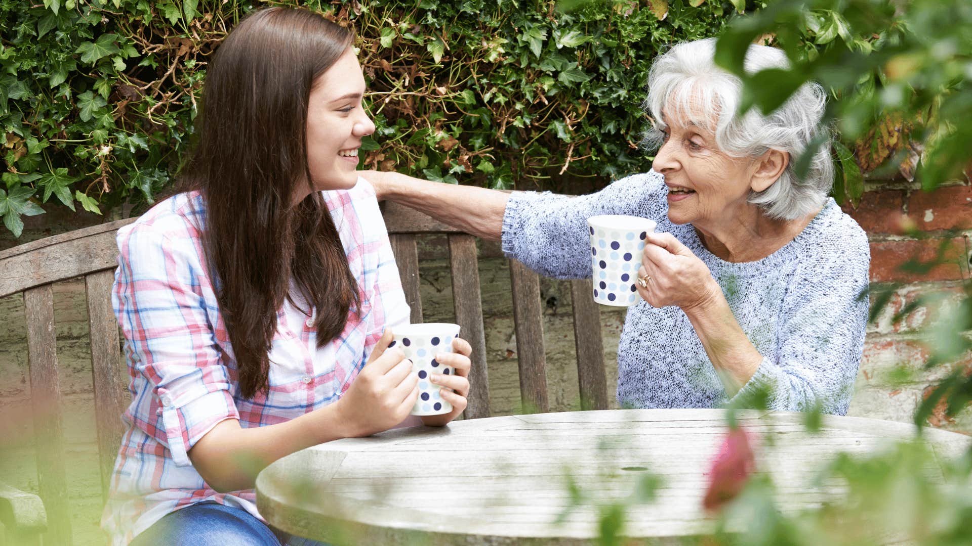 older woman and younger woman enjoying a beverage together