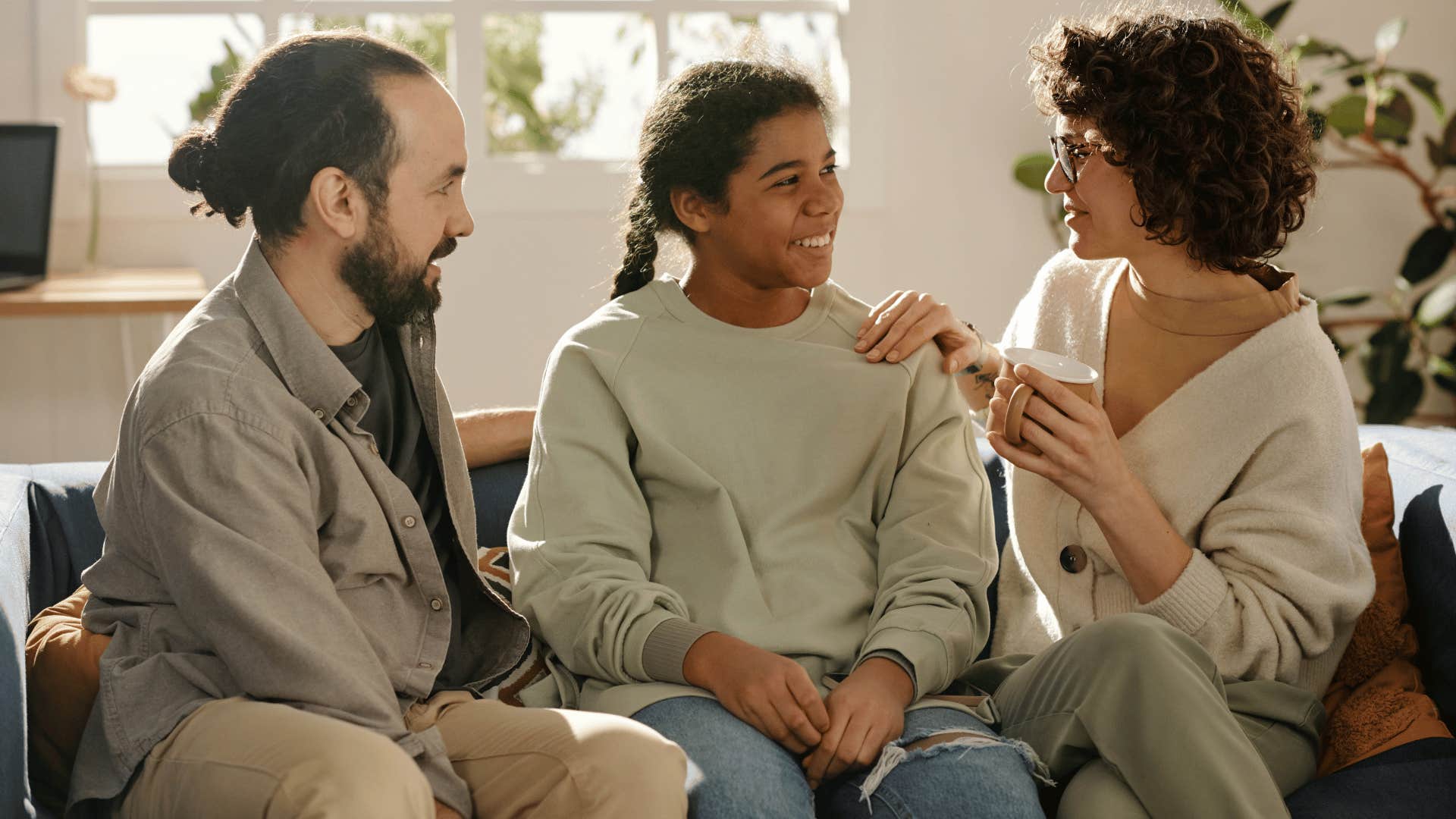 daughter sitting down and talking to parents