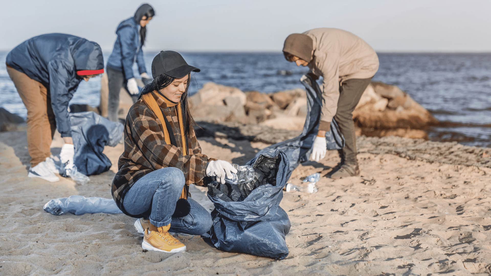 people cleaning up beach