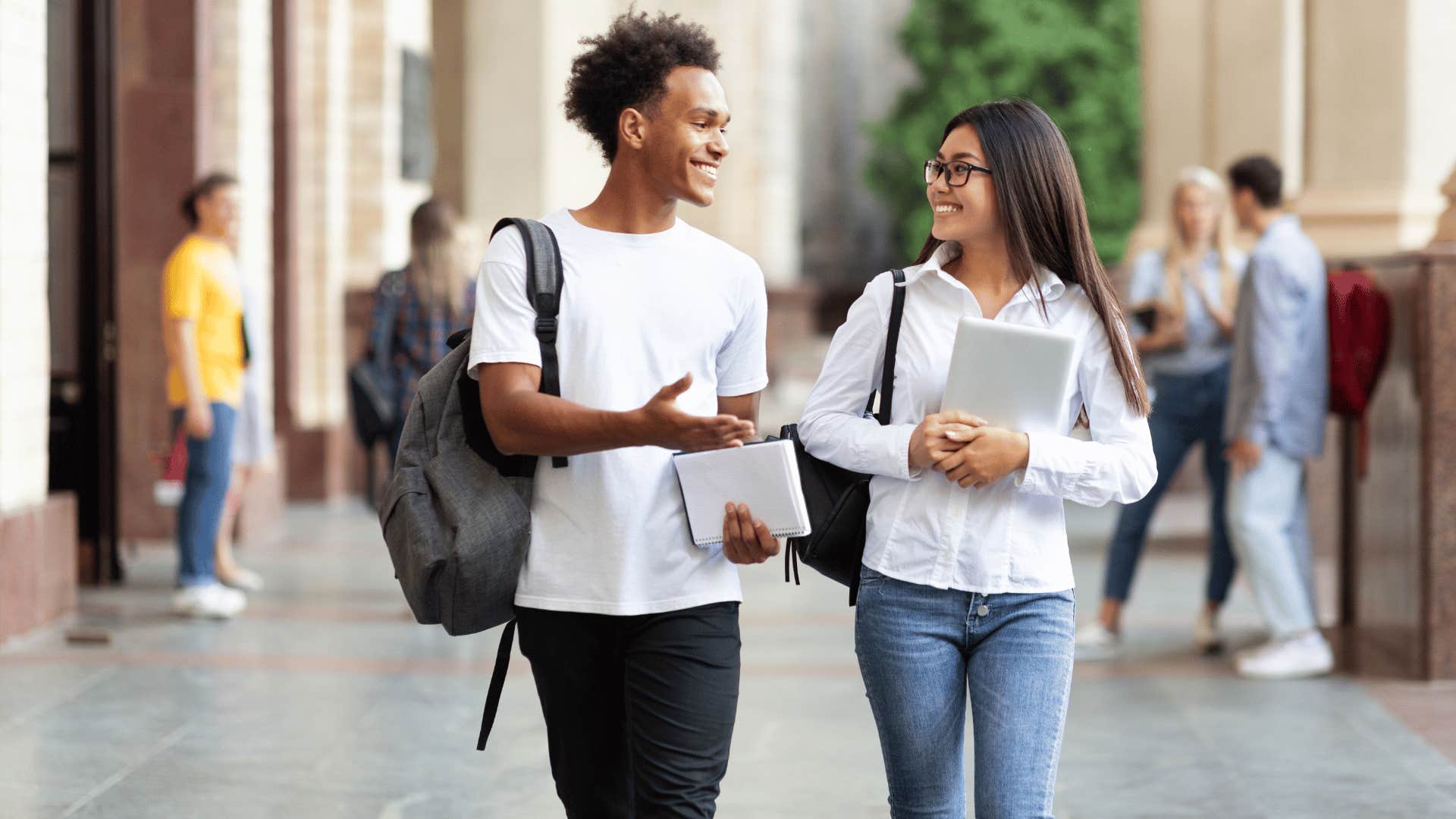 young man and woman chatting while walking