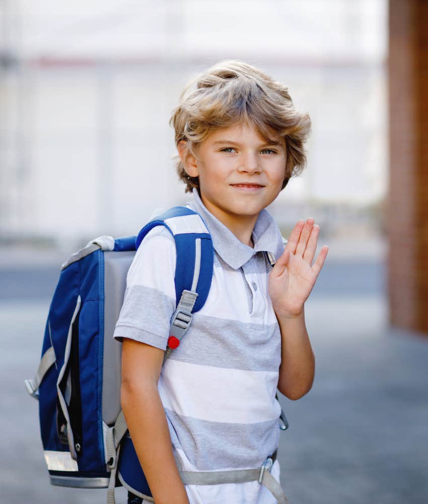 little boy on first day of school waving