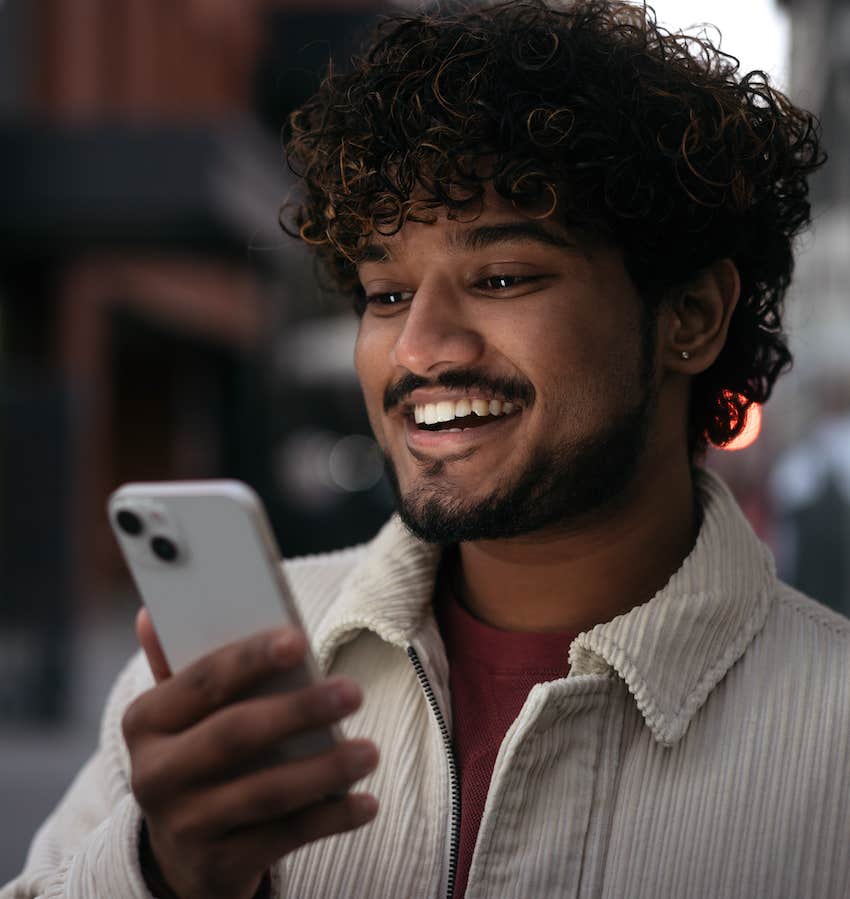 He is happy looking at his phone