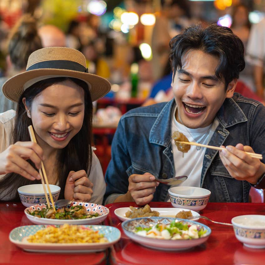 Excited couple eat at restaurant