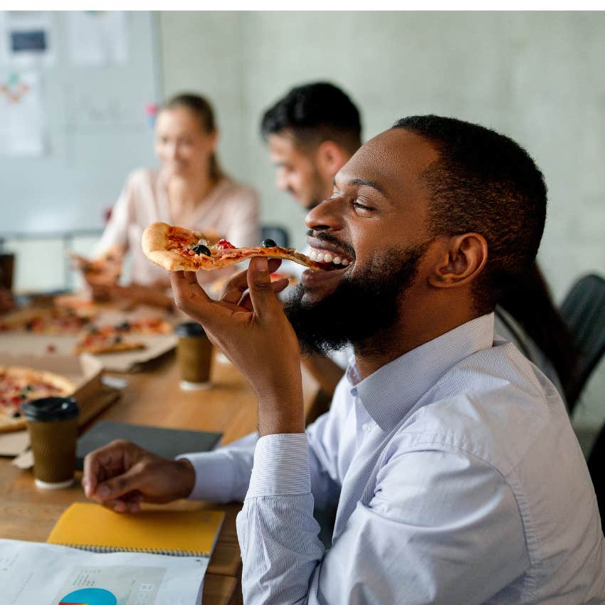 Worker eating on his lunch break in a shared staff room. 