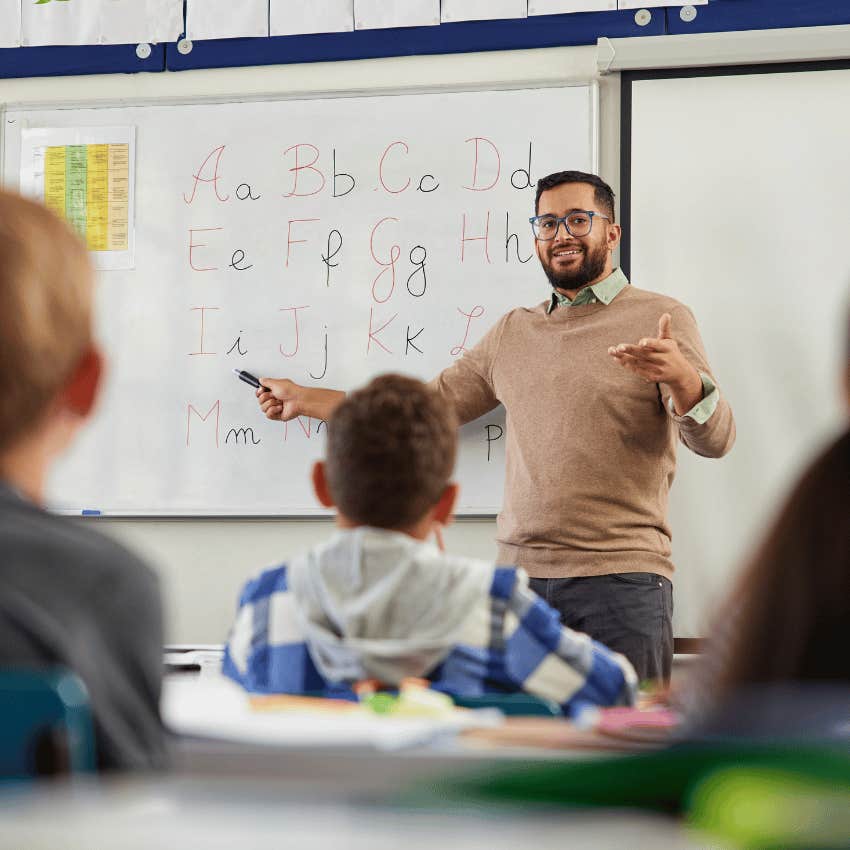 male teacher standing in front of his classroom