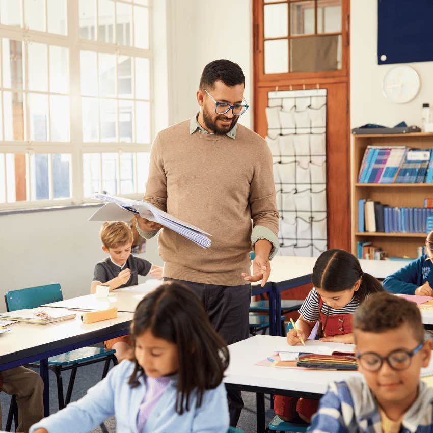 male teacher walking around a classroom