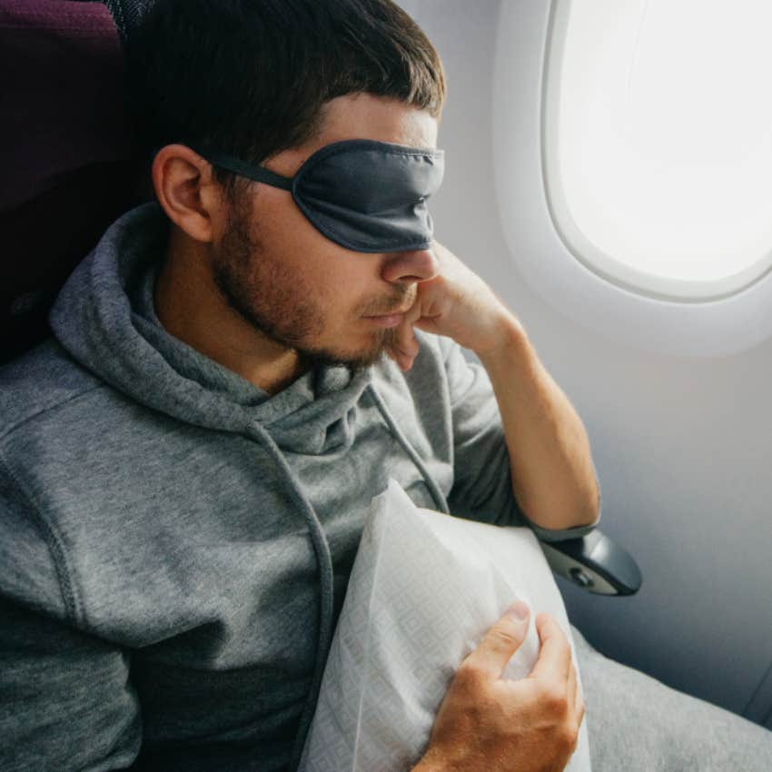 man asleep on plane 