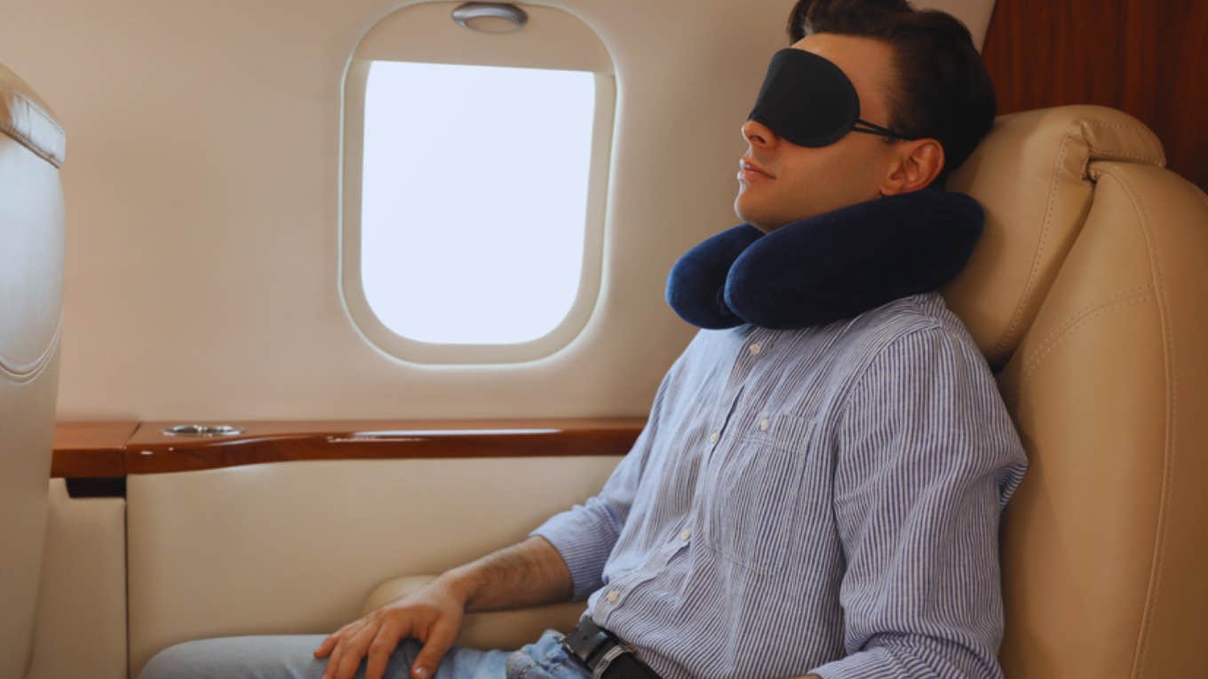 man sleeping on plane 