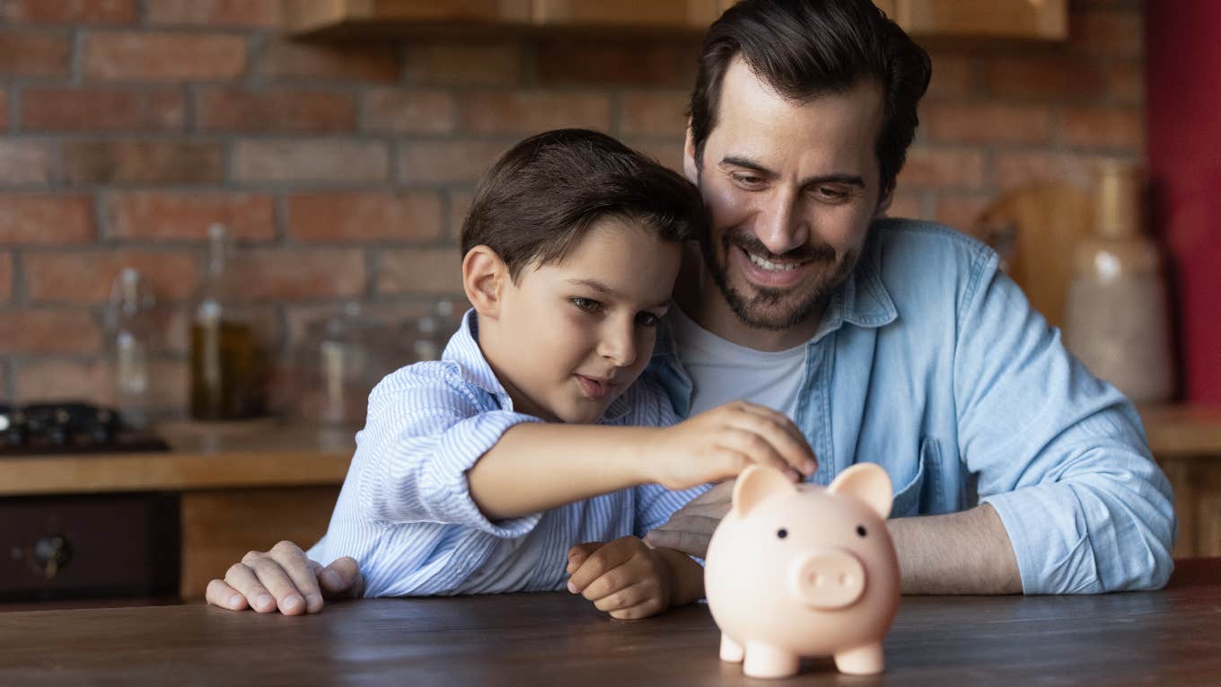 Dad teaching son how to save money