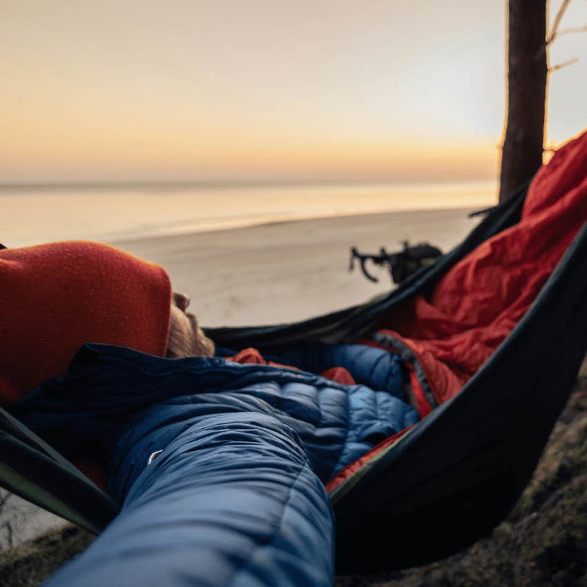 man sleeping on hammock near the beach