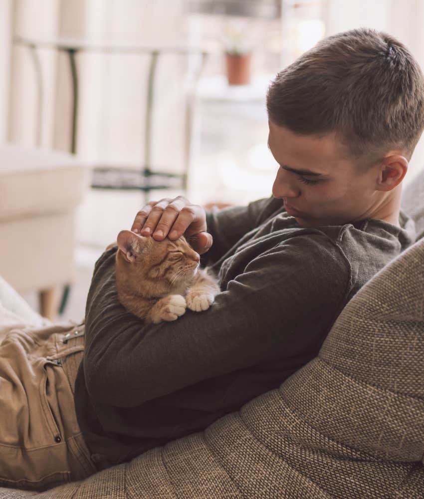 Man snuggling with his cat