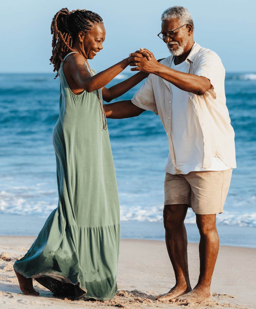 Older couple dance on the beach