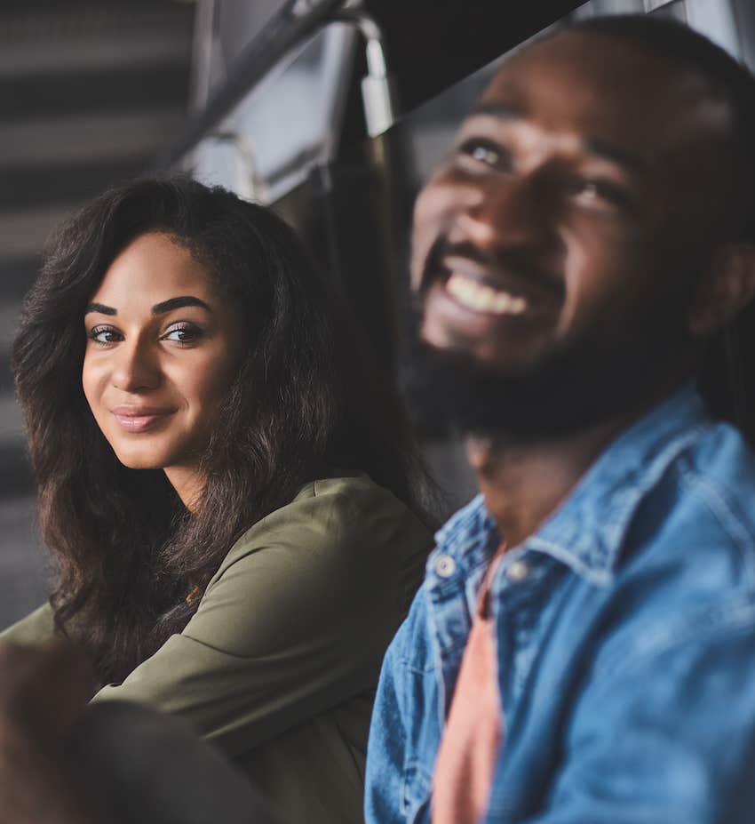 Smiling man and happy woman sit together