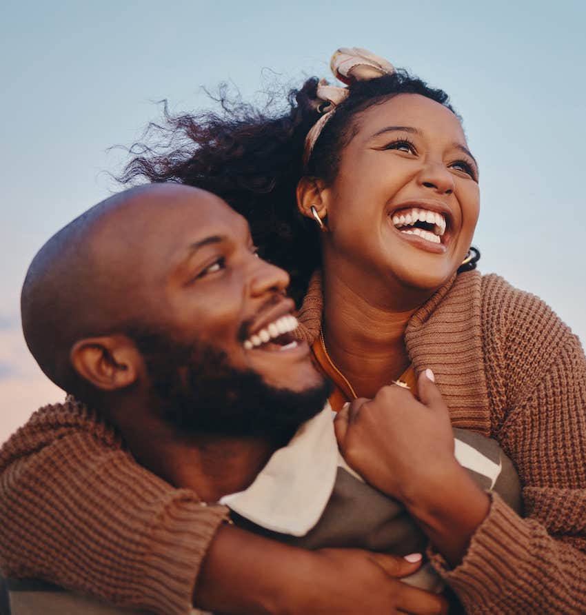 Couple has big smiles while hugging