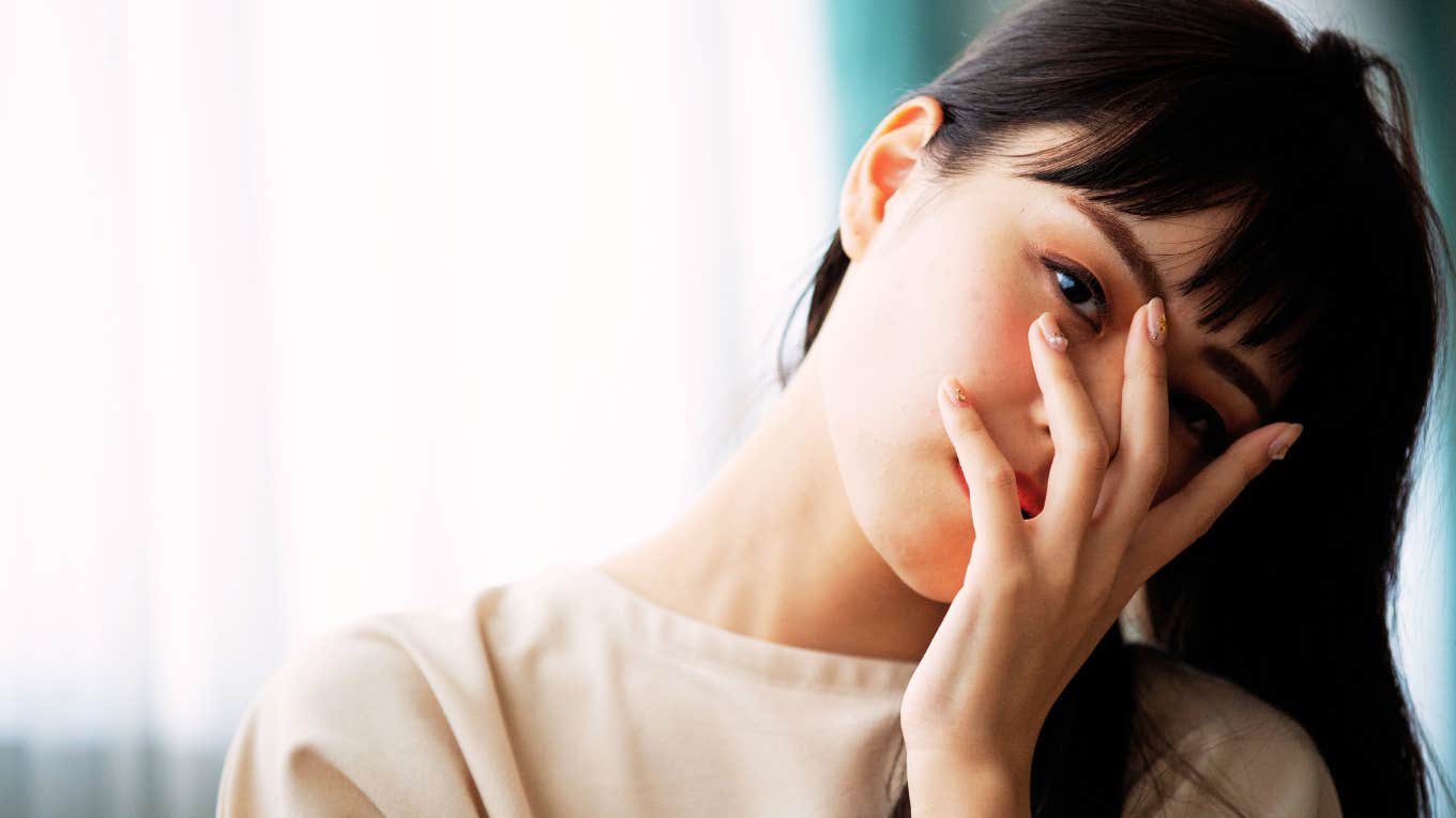 Woman making a little mistake and being taken less seriously by man, hand on her face. 