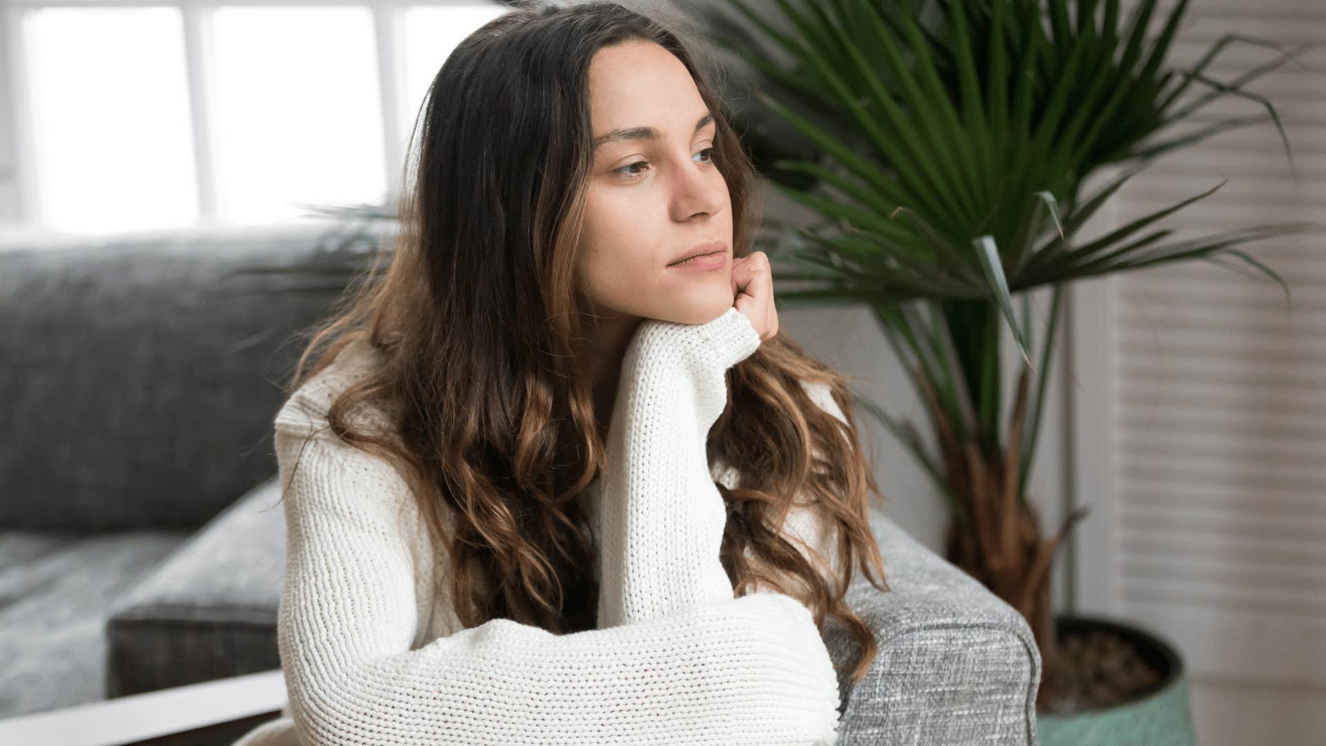 woman staring out of window