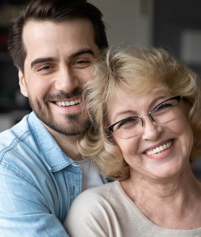 mom and adult son smiling