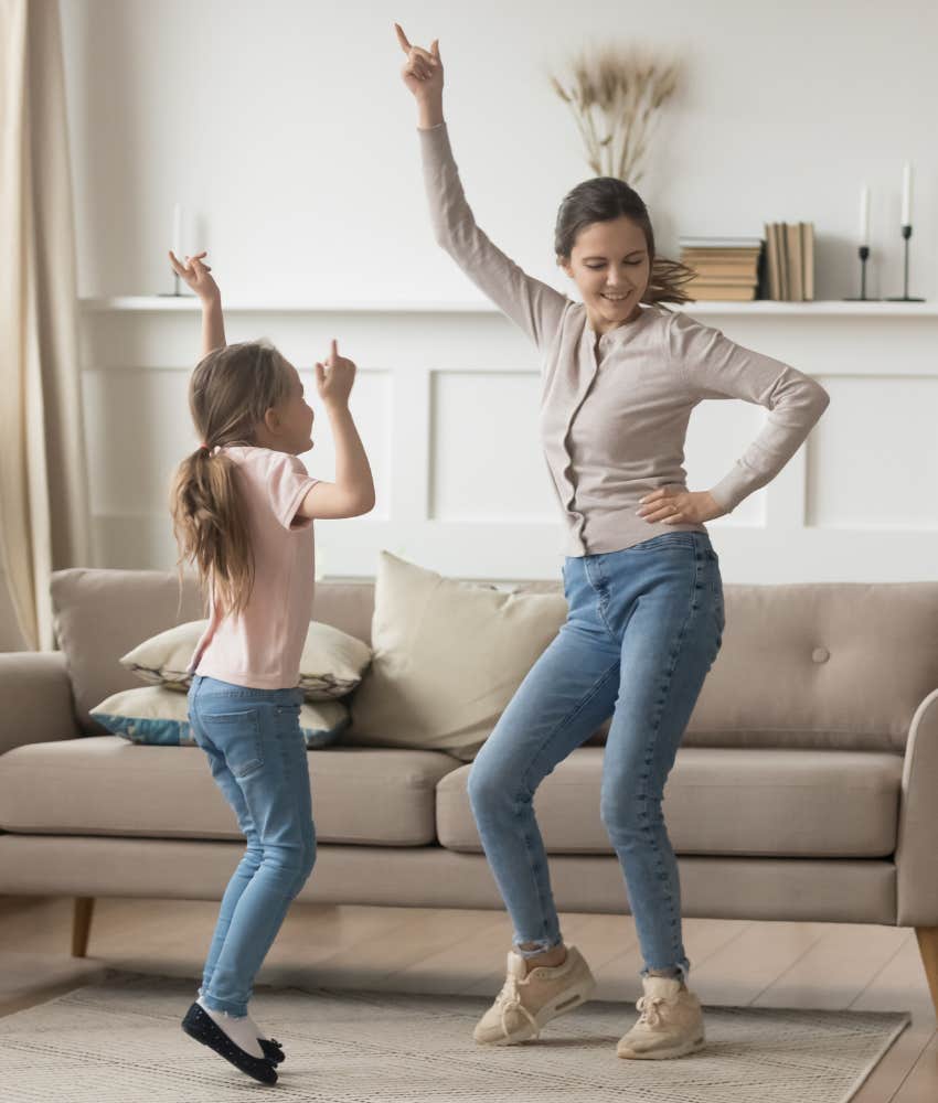 mom and daughter dancing and having fun