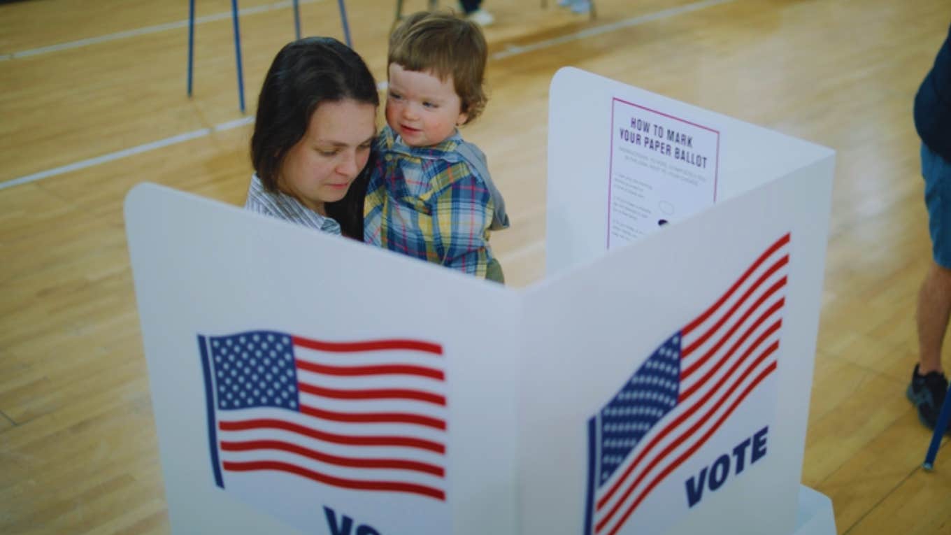 woman voting with son