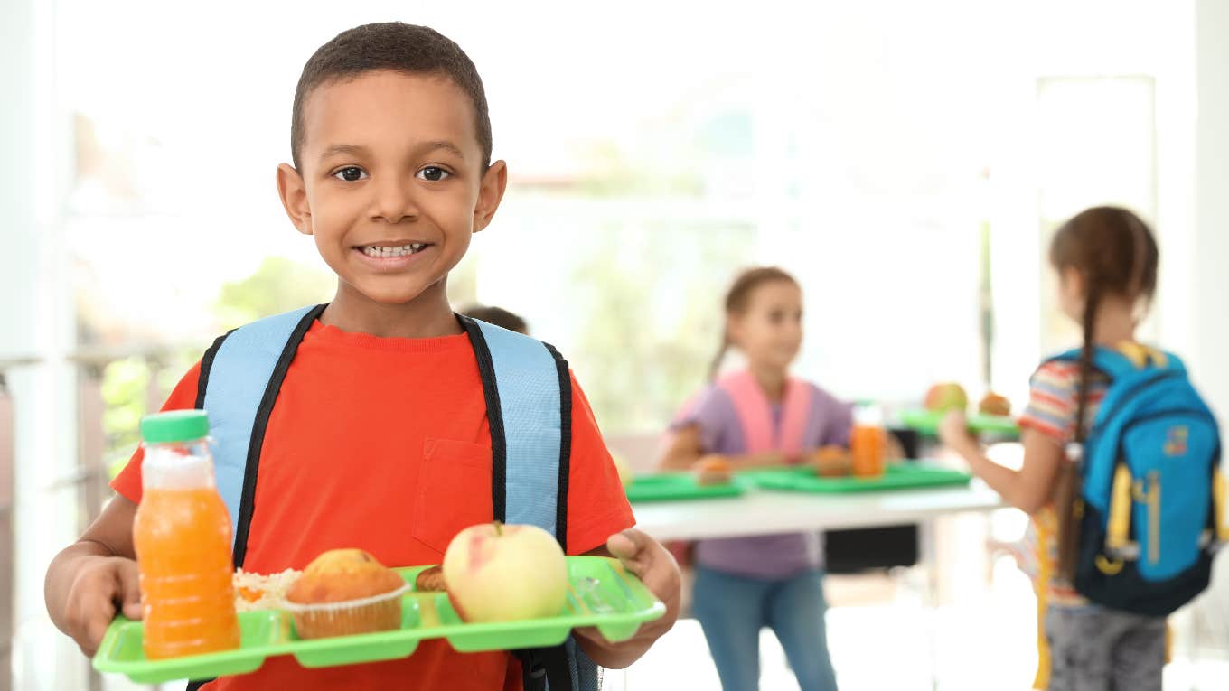 Kid holding school lunch tray