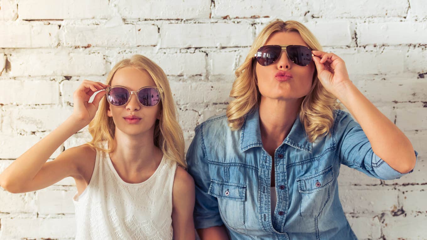 mom and teen daughter posing for camera in sunglasses