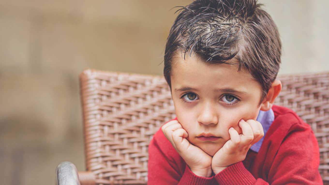 Sad little boy with wet hair