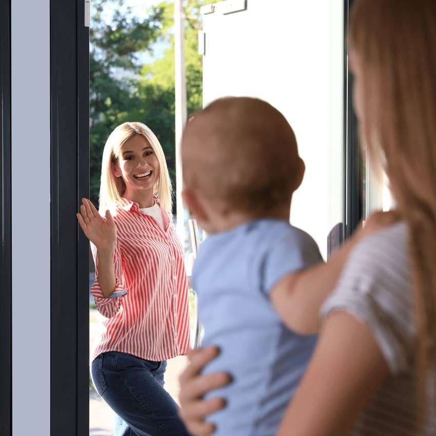 mom waving at teenage babysitter holding baby