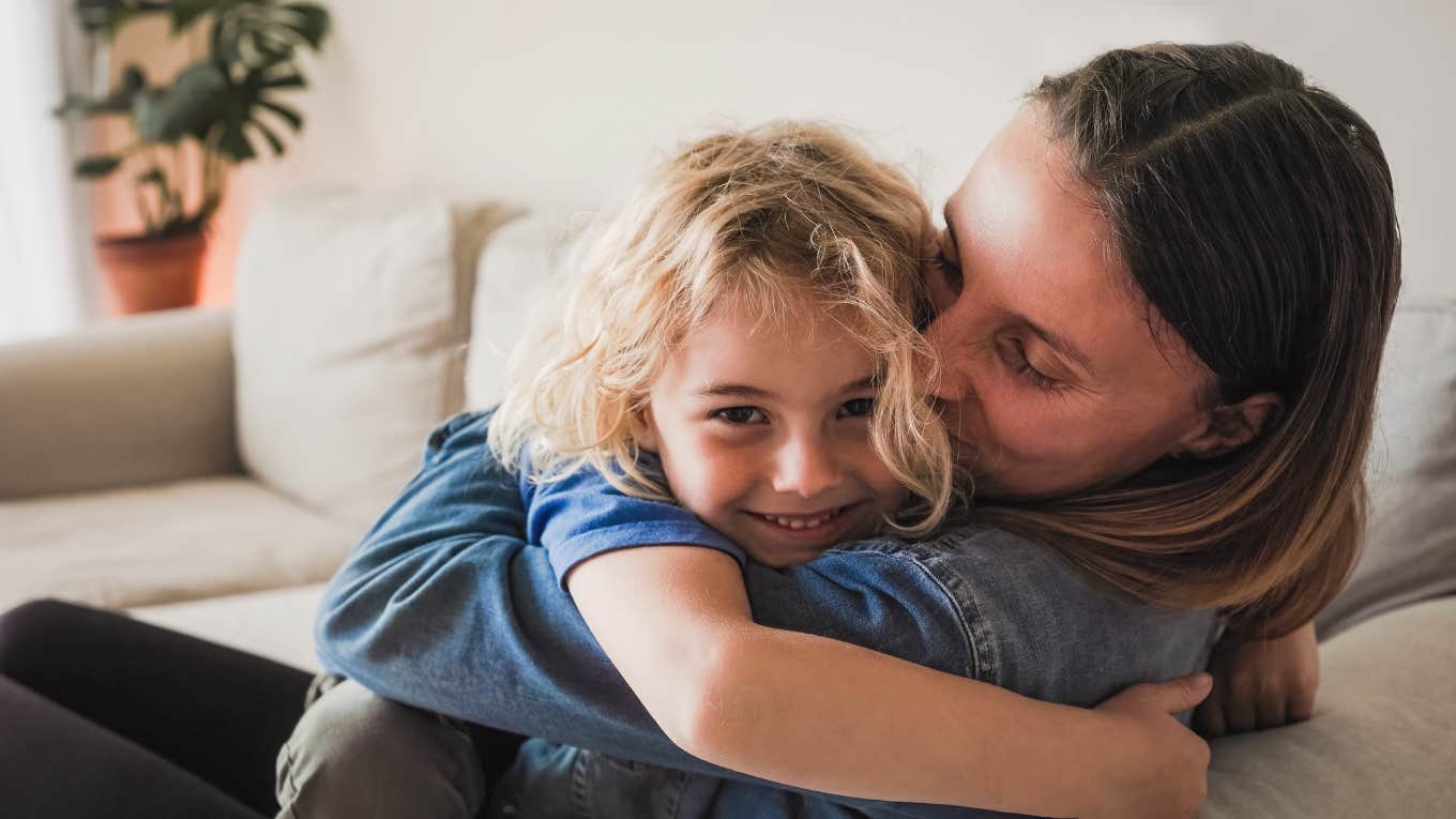 mom and son hugging at home on couch