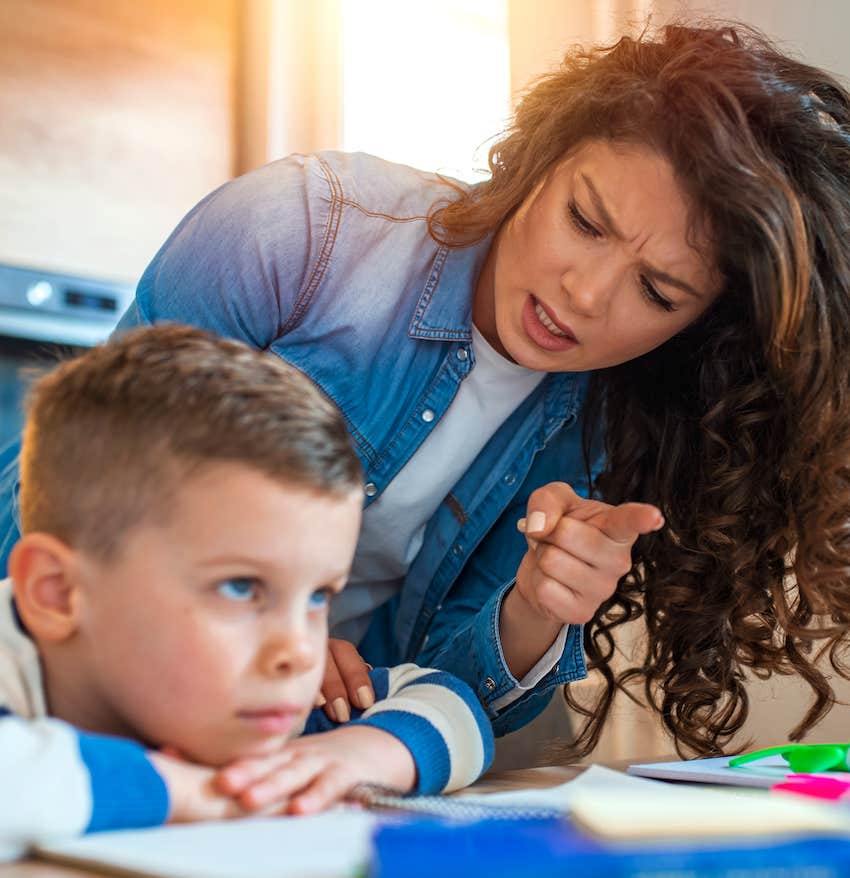 Woman scolds child who put shead down and looks ahead