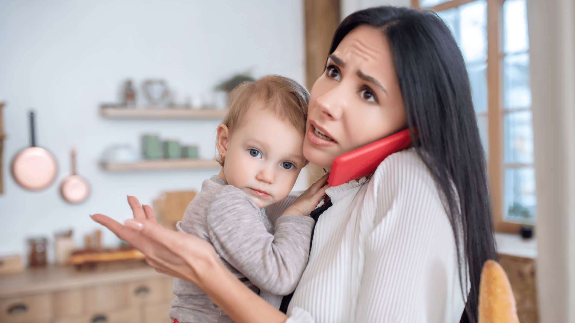 Woman on phone holding baby