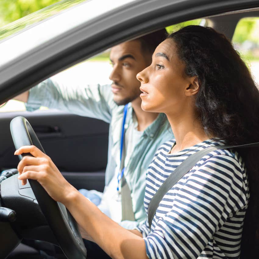 Woman looking nervous while driving. 