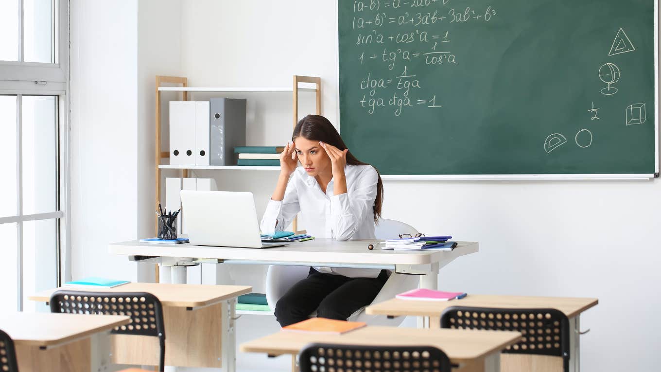 Teacher worried while sitting at her desk