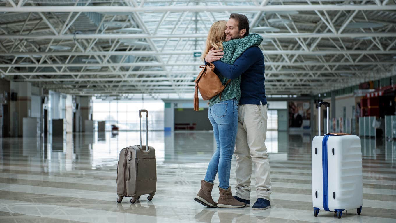 Couple hugging at the airport