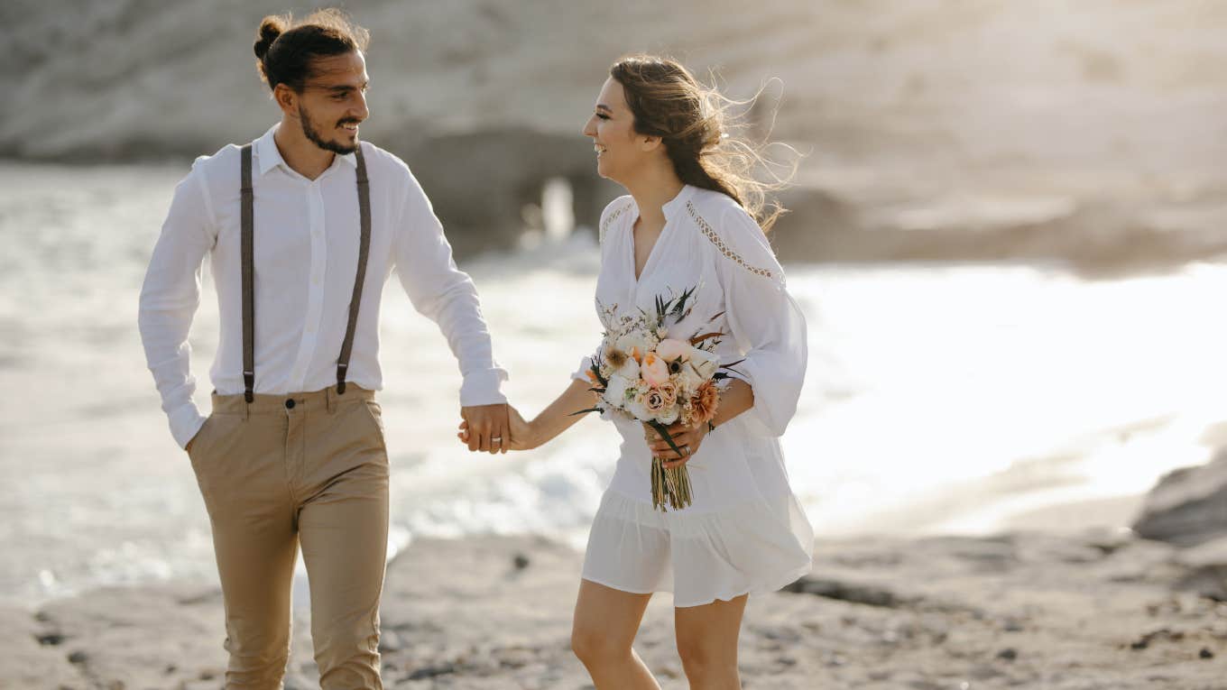 newlyweds on a beach after wedding ceremony