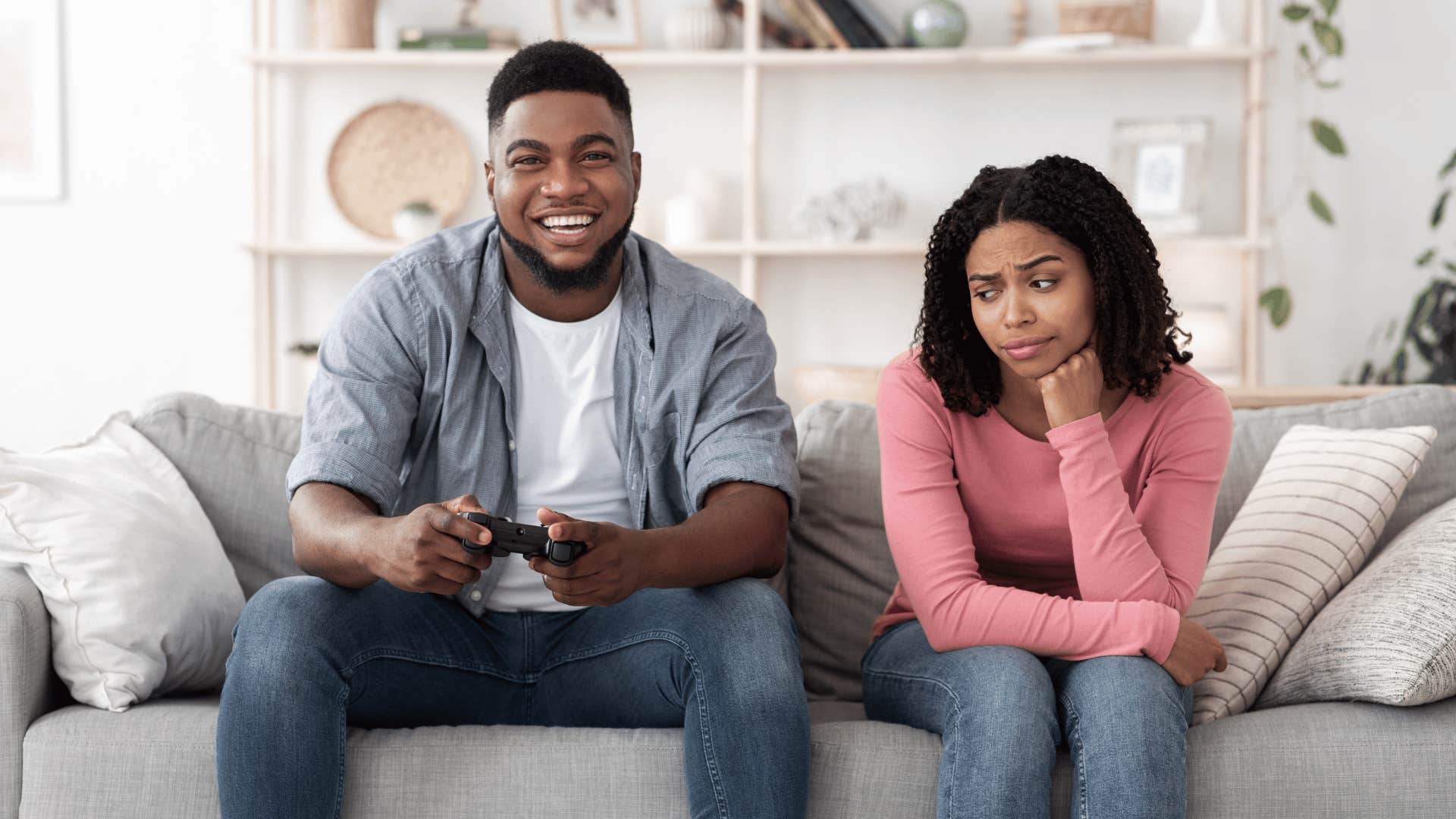 He plays video game, she looks bored