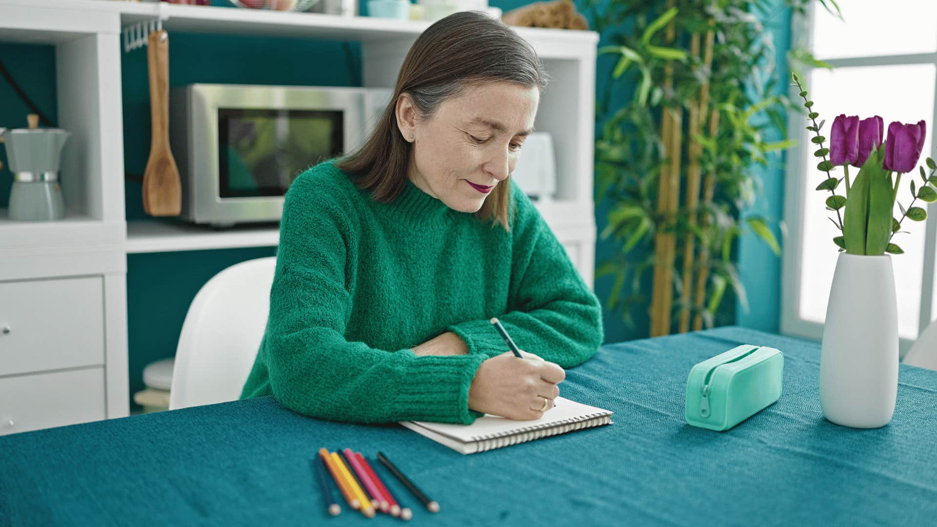 woman sketching on notebook