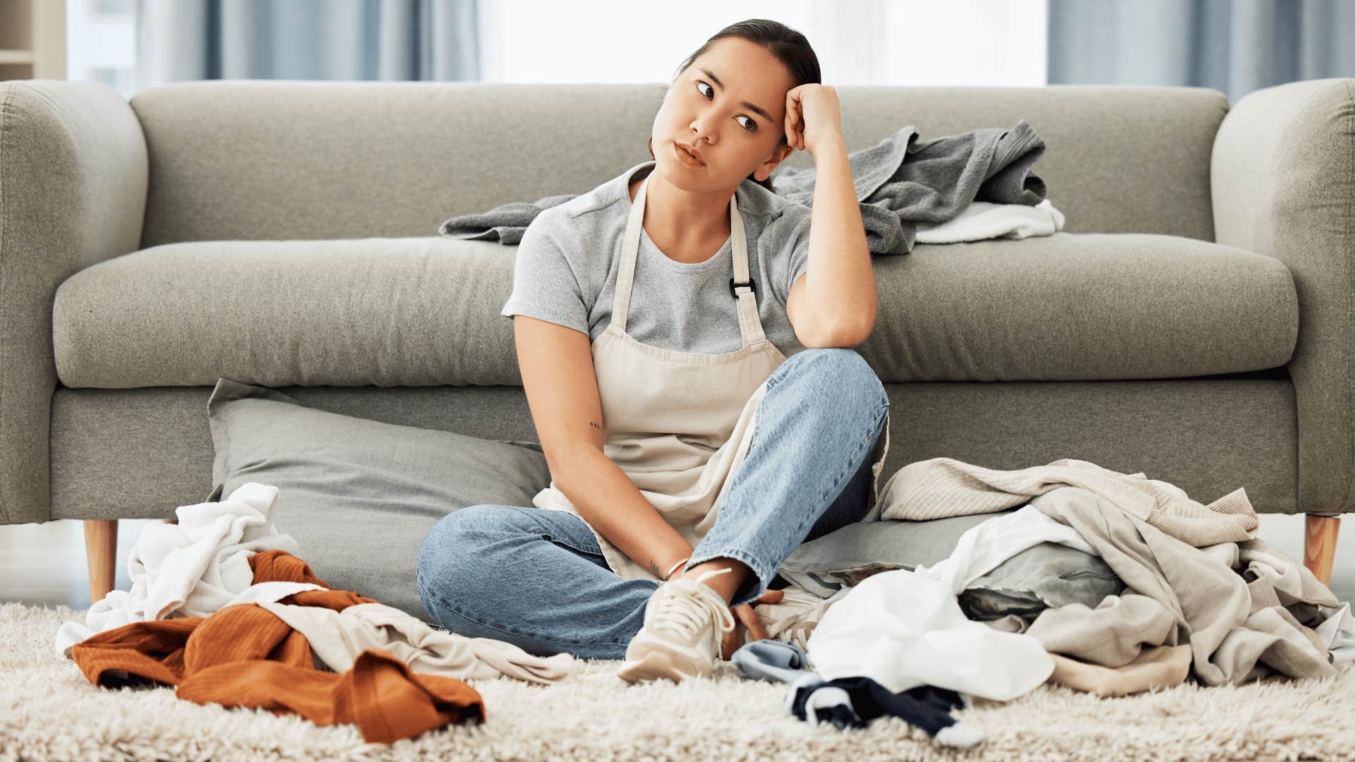 woman sitting down with a mess around her