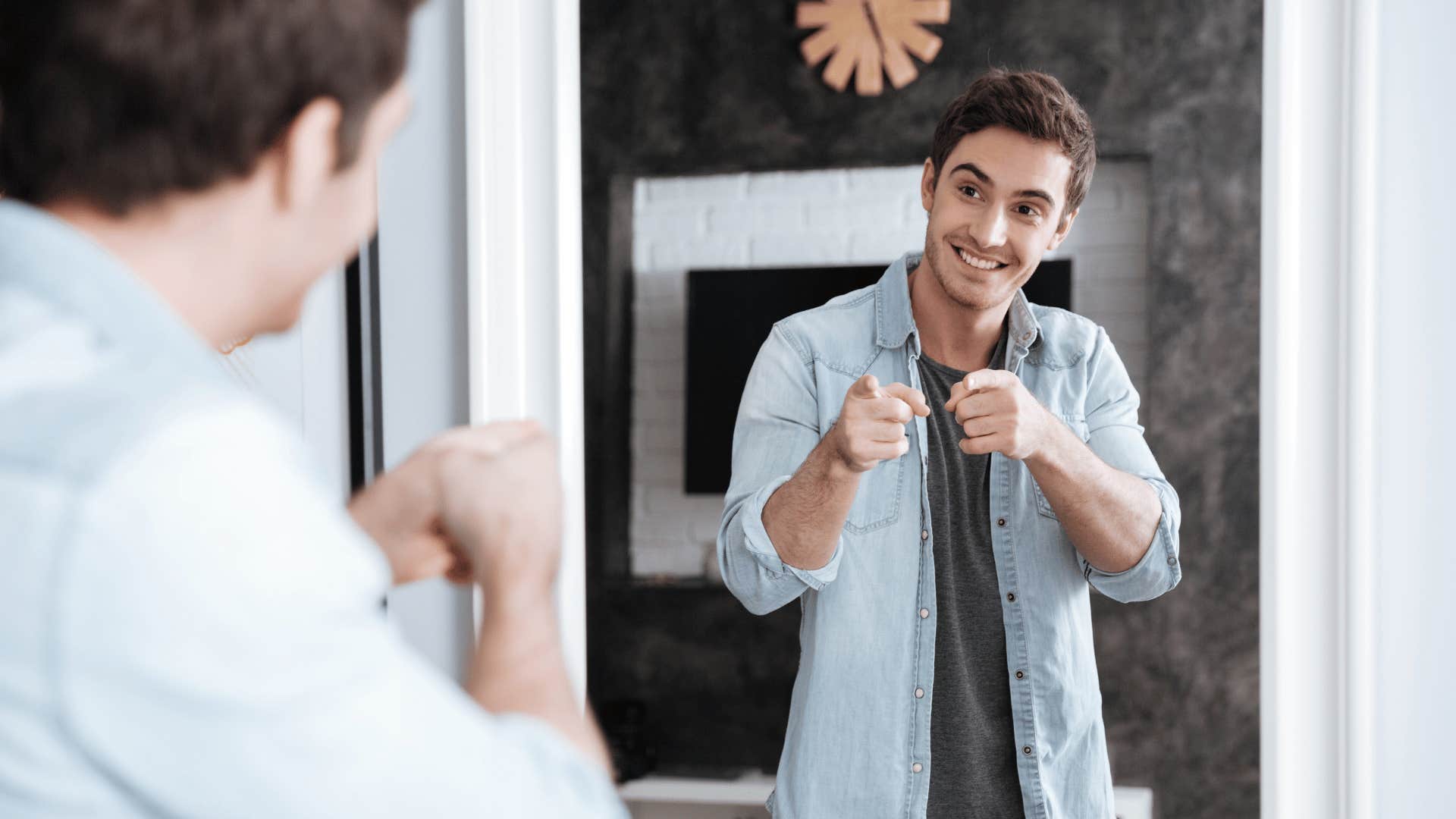 man looking at himself in the mirror 