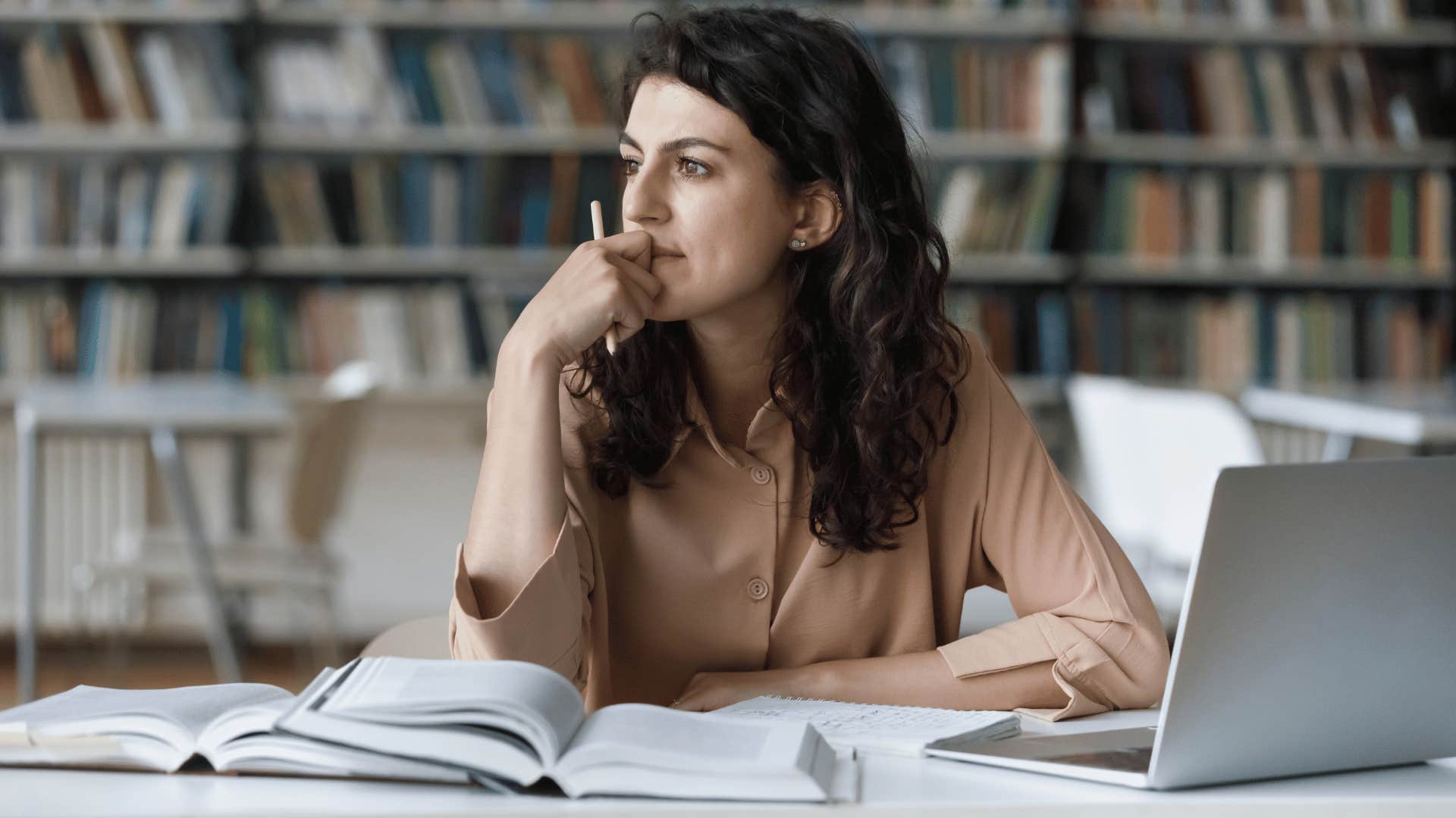 woman reflecting while she is supposed to be studying 