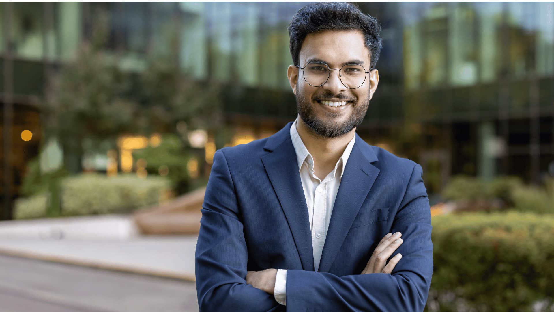 man smiling at camera crossing arms 