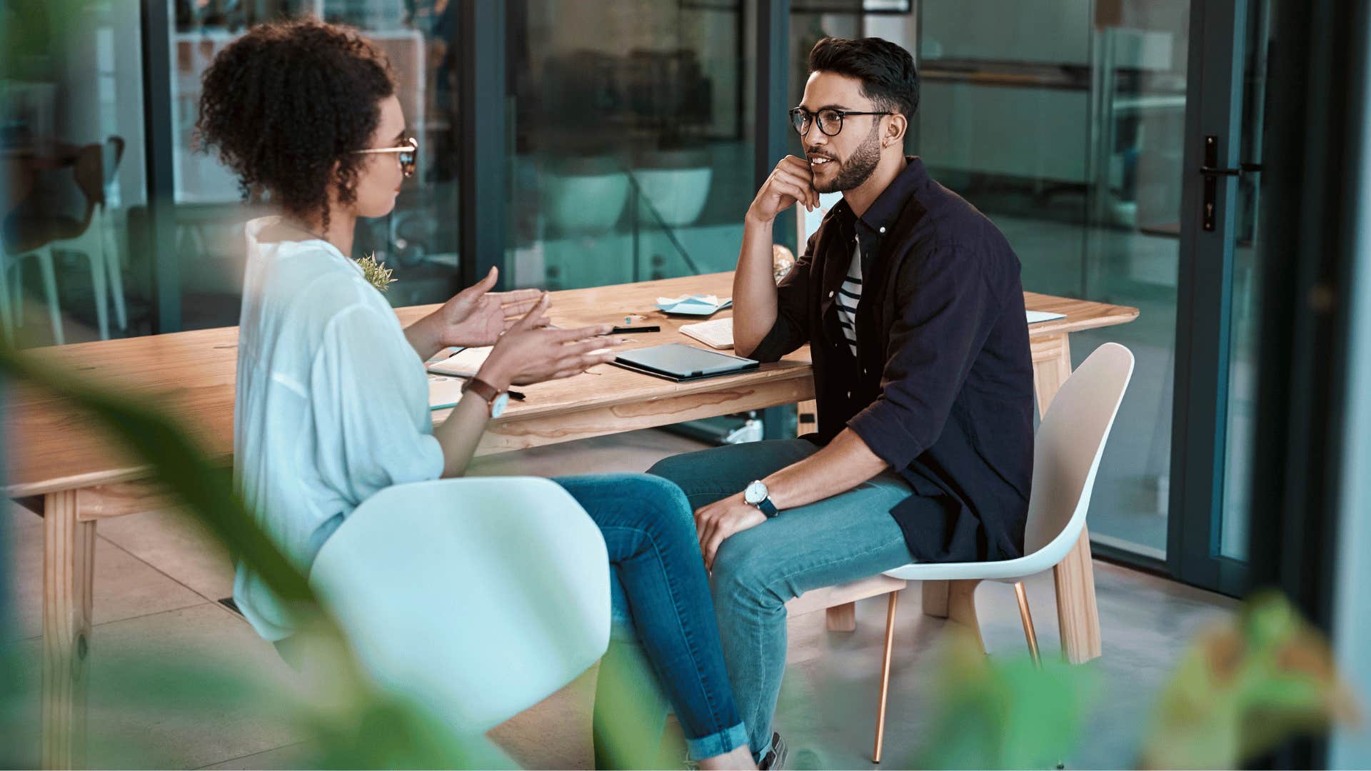 man and woman chatting while sitting on chair 