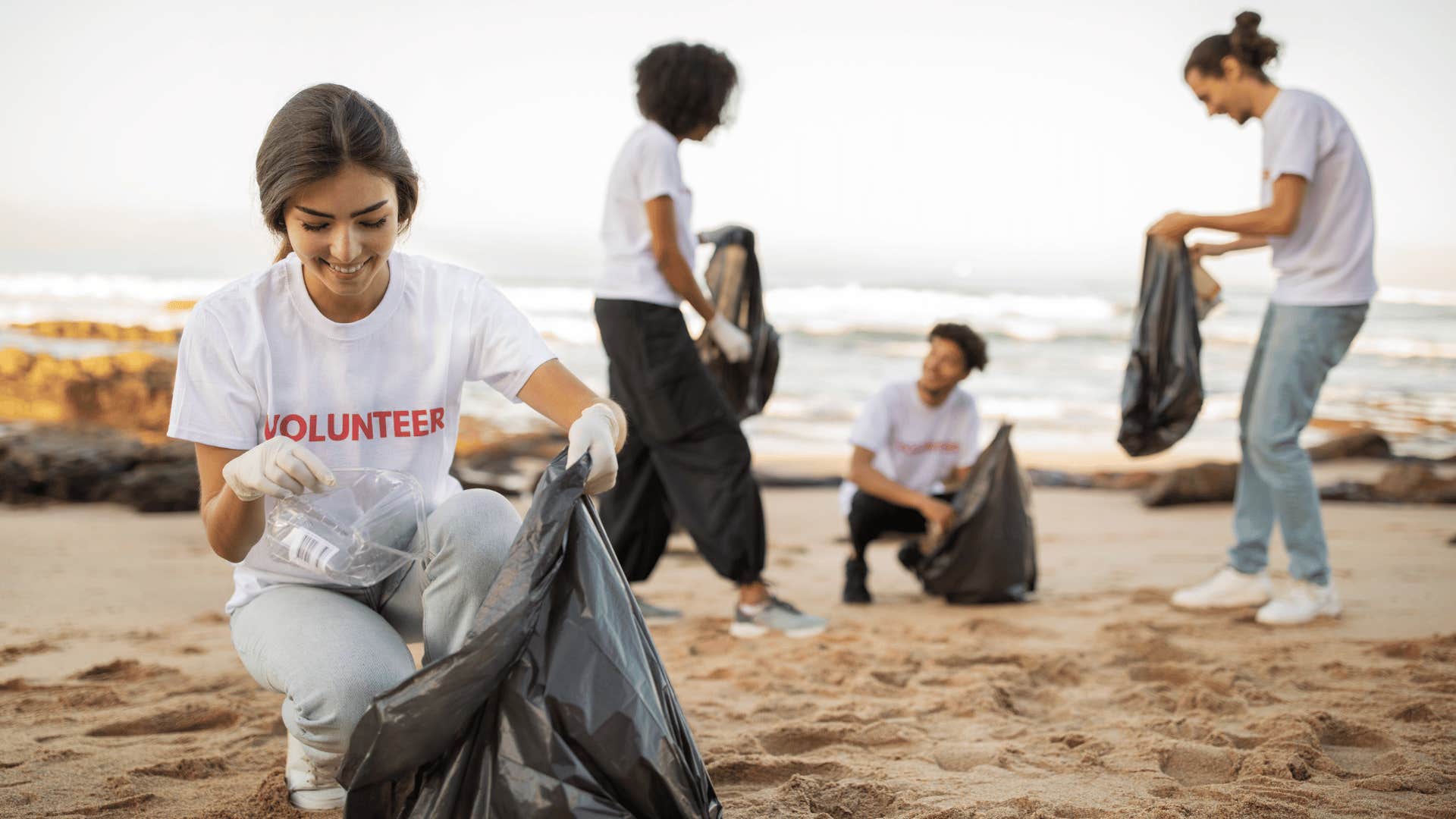 people volunteering and cleaning up the beach