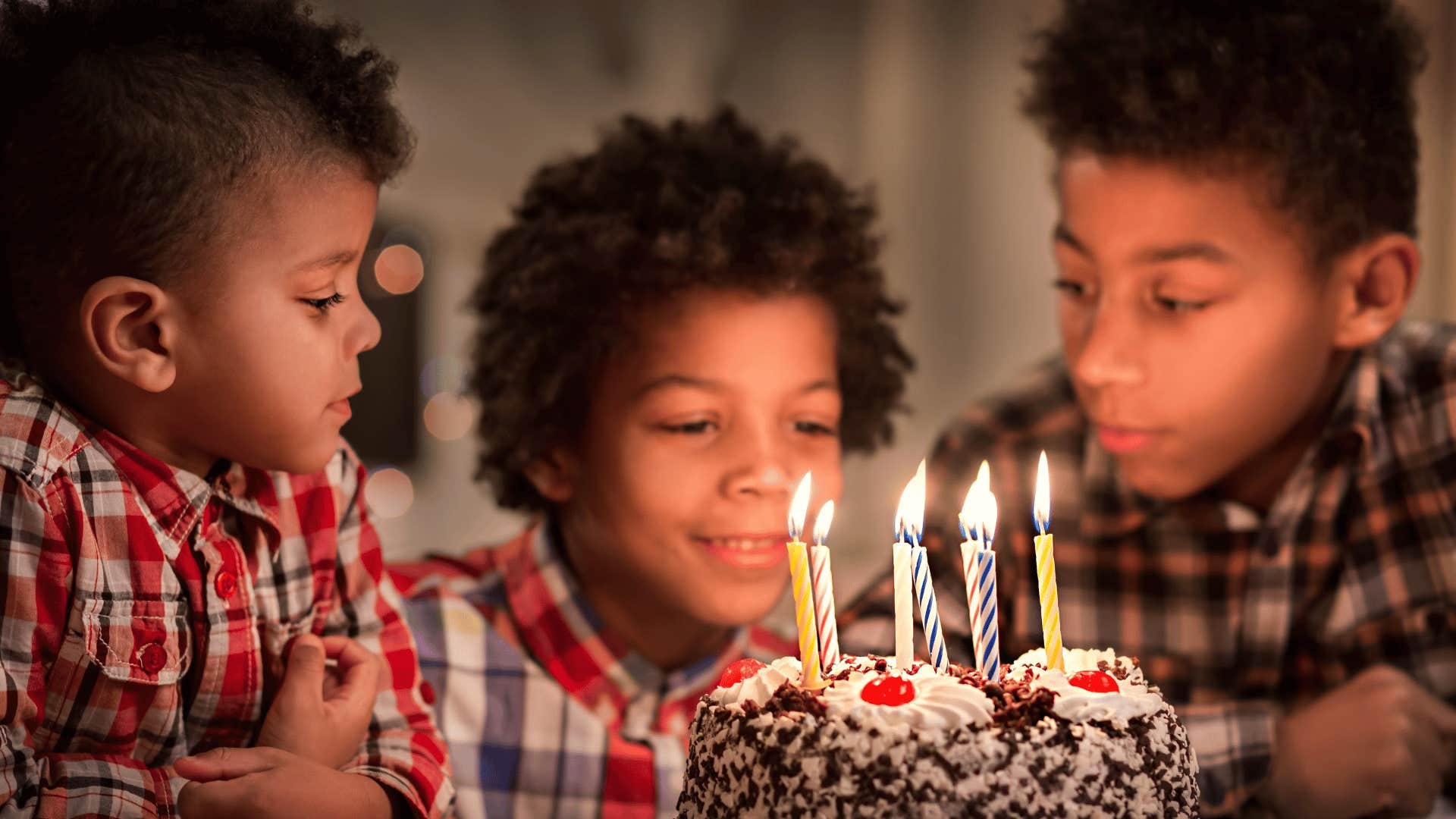 three boys and a birthday cake