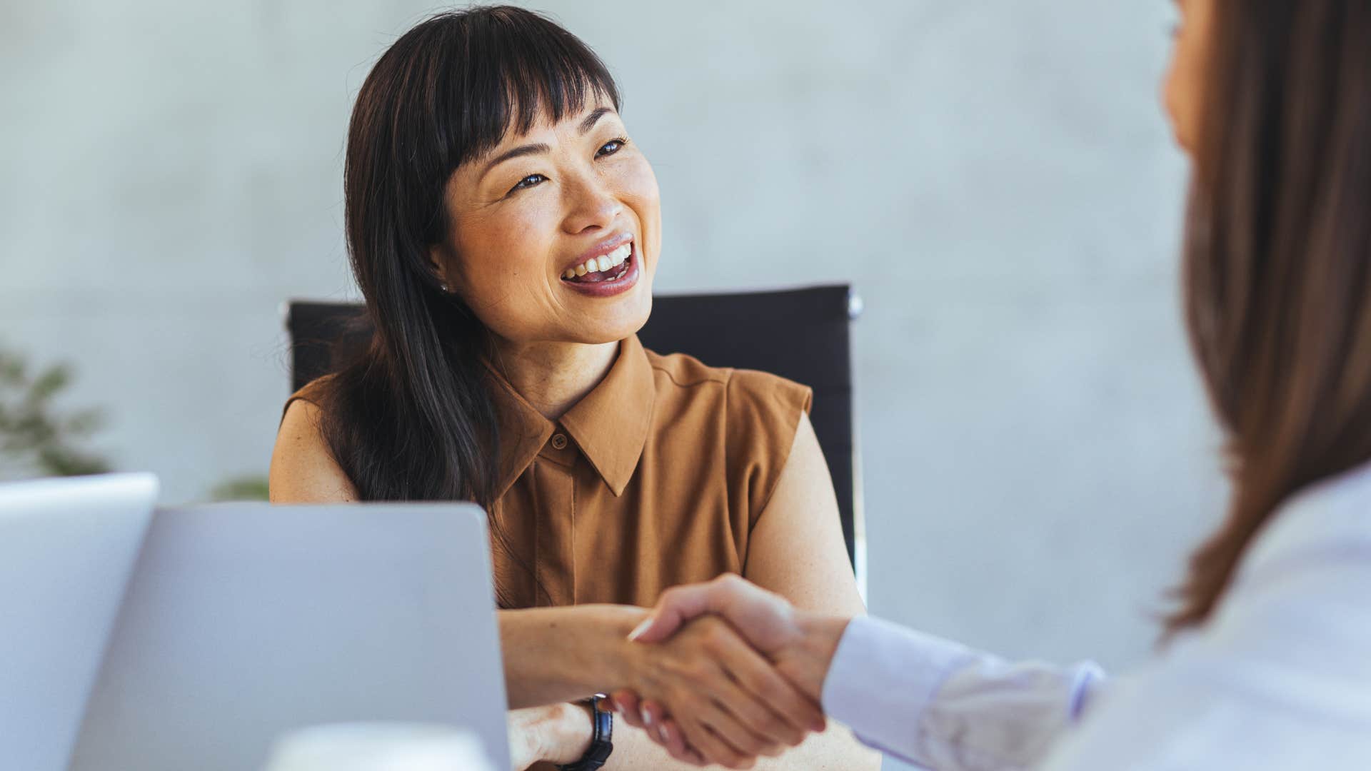 Gen Z woman following old school manners of shaking hands