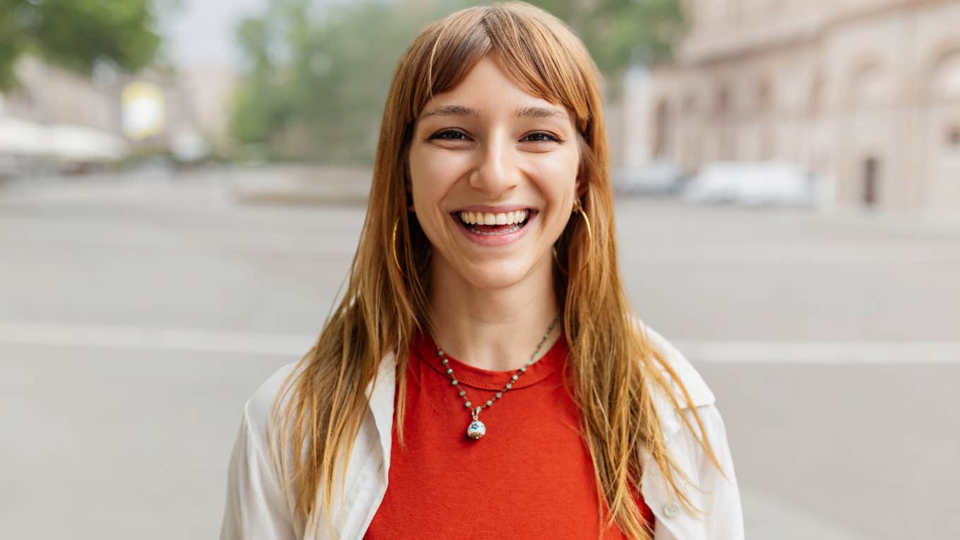 Gen Z woman smiling at the camera. 