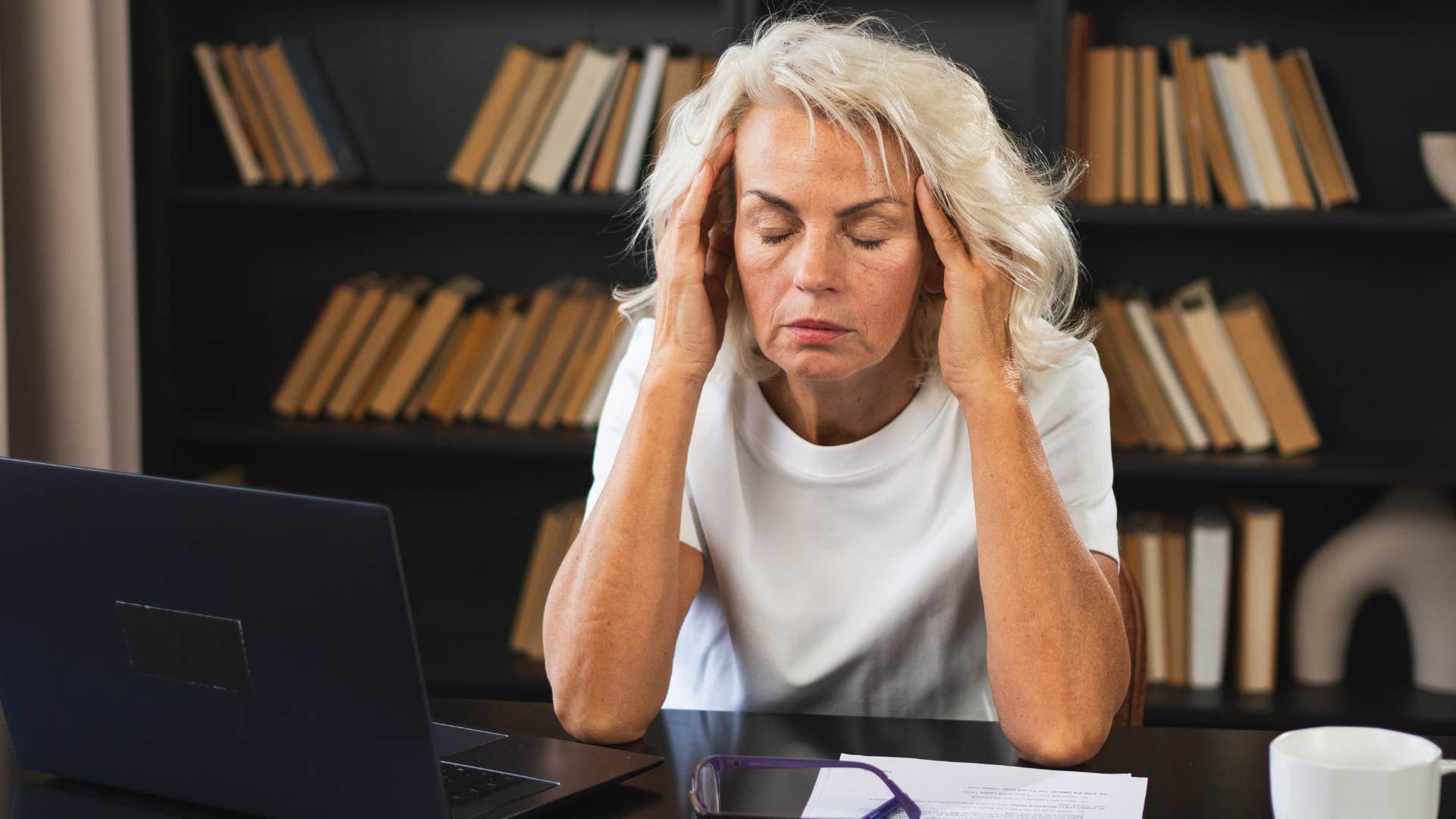 Woman looking frustrated at her desk.