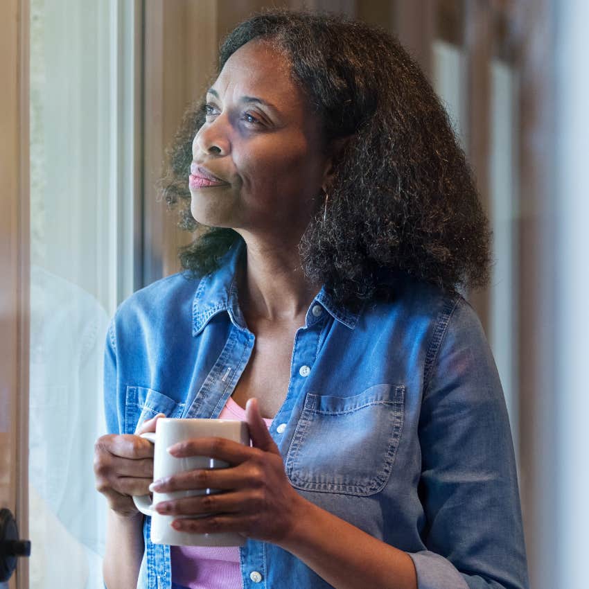 No-contact mother looking solemnly out of the window. 