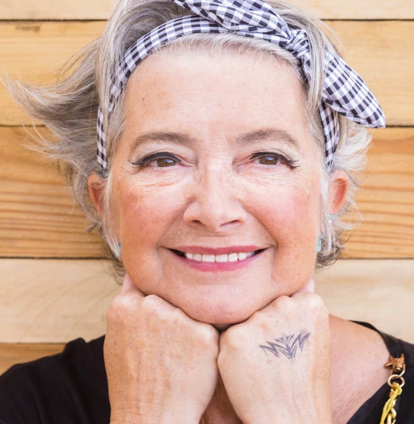 older woman with flower tattoo on the back of her hand