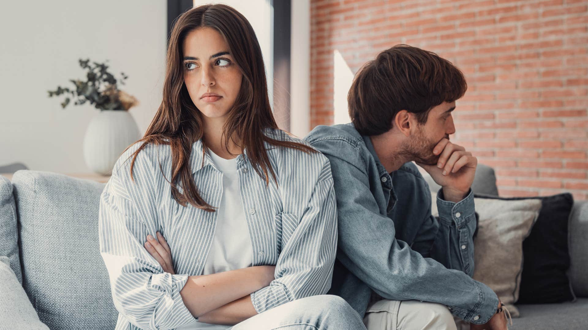 Woman looking annoyed next to her boyfriend. 