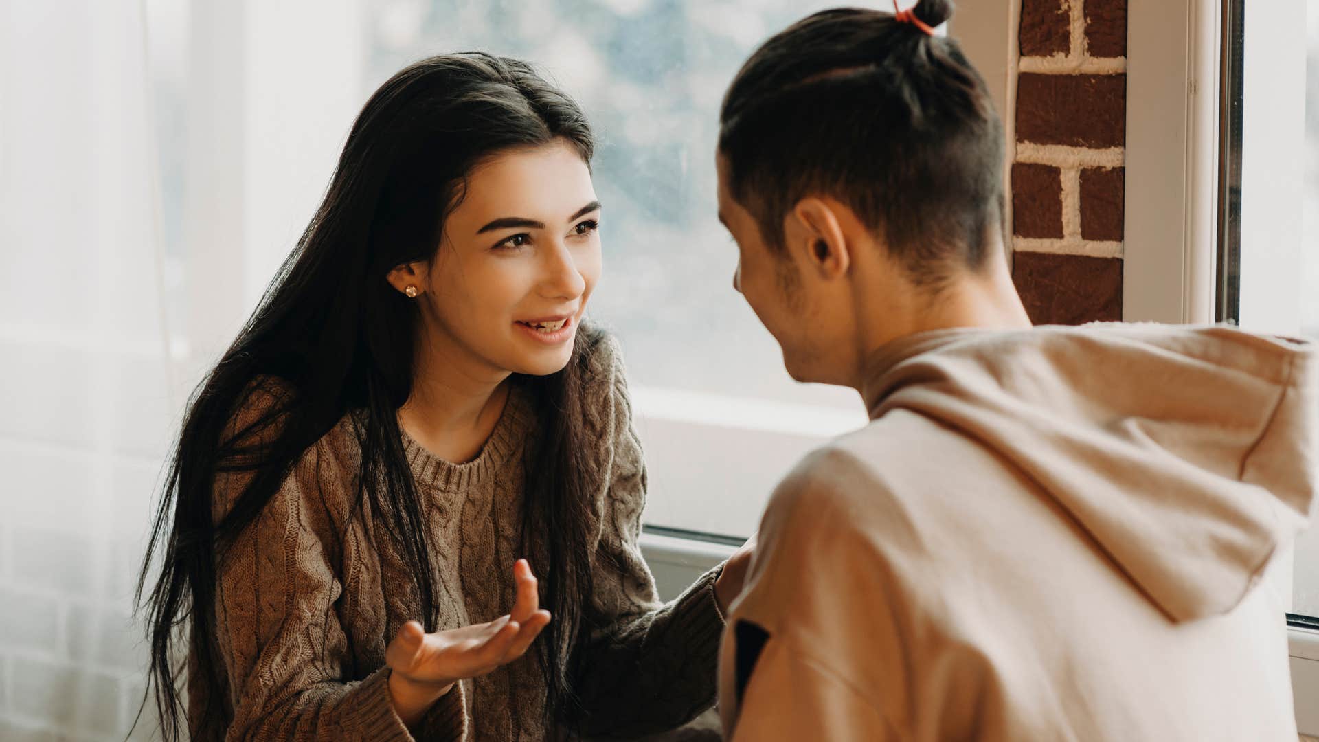 Woman talking intently to her boyfriend. 